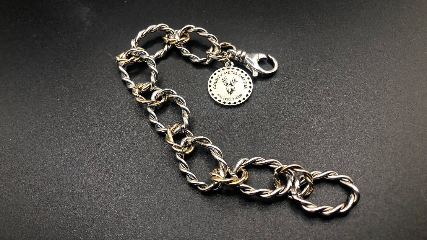 Sterling silver and 1/20 14k twisted oval link bracelet with large charm