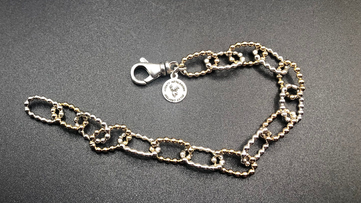 Hand crafted sterling silver and 1/20 14k oval beaded link bracelet