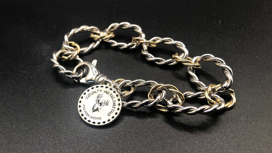 Sterling silver and 1/20 14k twisted oval link bracelet with large charm